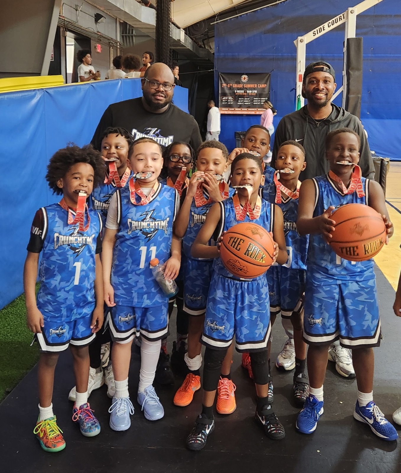 A Crunchtime team wearing their medals after a summer camp championship